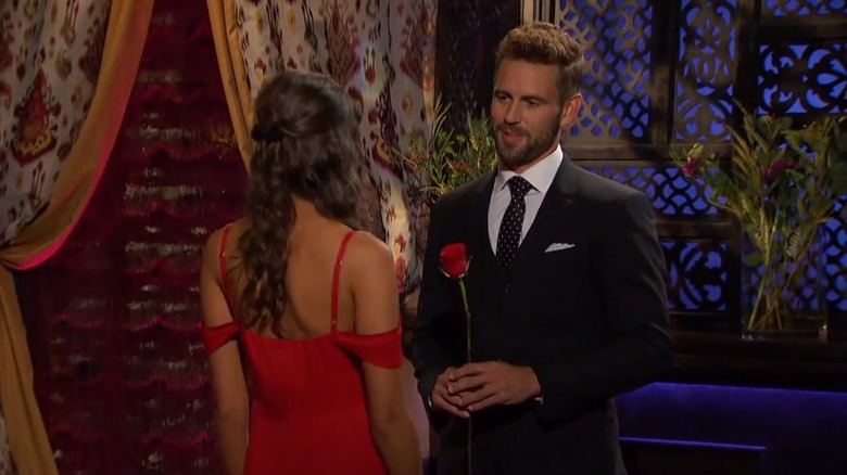 Bachelor franchise star Nick Viall handing Whitney Fransway a rose