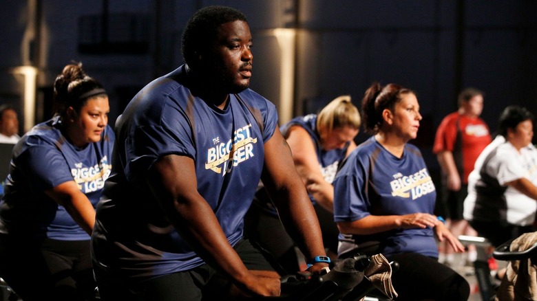 Damien Woody and other contestants cycling on The Biggest Loser