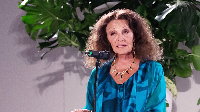 Diane von Furstenberg speaking to a microphone