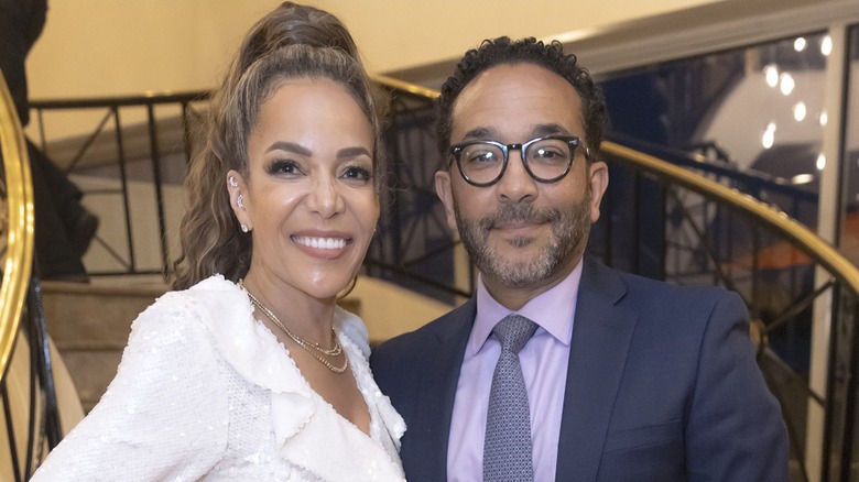 Sunny Hostin and Dr. Emmanuel Hostin in front of stairs