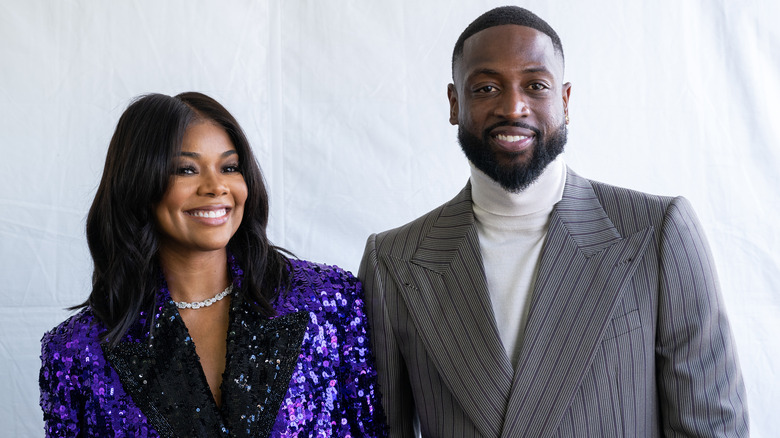 Gabrielle Union and Dwyane Wade standing together, smiling