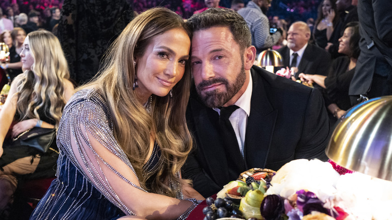 Jennifer Lopez and Ben Affleck leaning their heads together while smiling for the camera