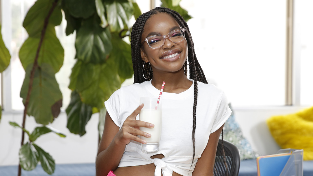 Marsai Martin holding glass of milk