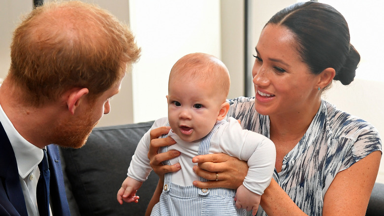 Meghan, Archie, and Harry playing