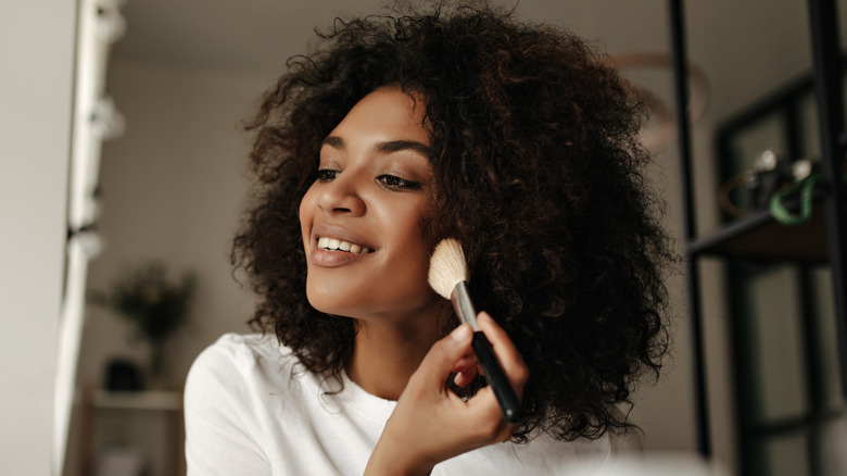 Woman applying face powder