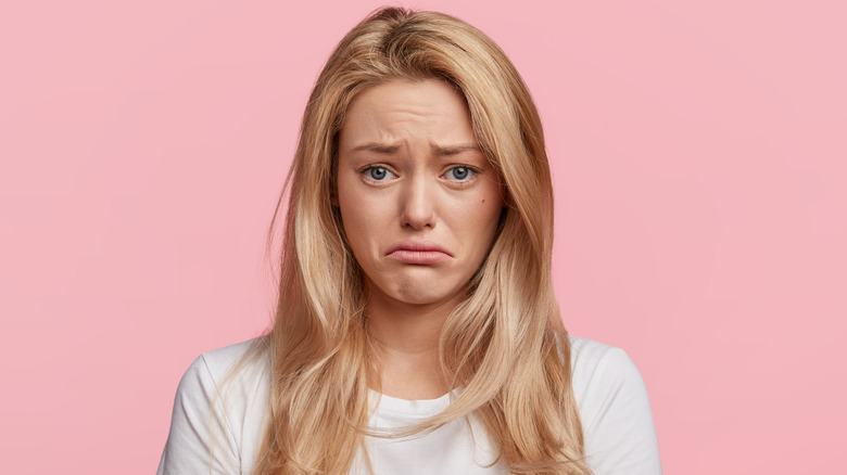 Woman frowning about hairstyle