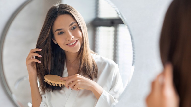 Woman brushing straight hair