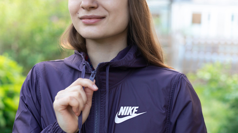 A woman with a Nike windbreaker