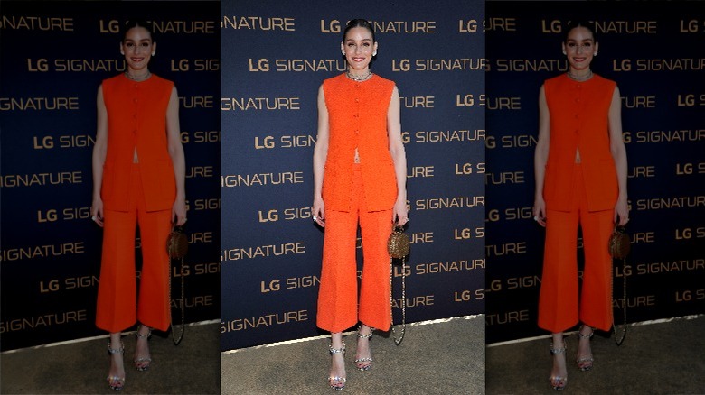 Olivia Palermo posing in orange outfit
