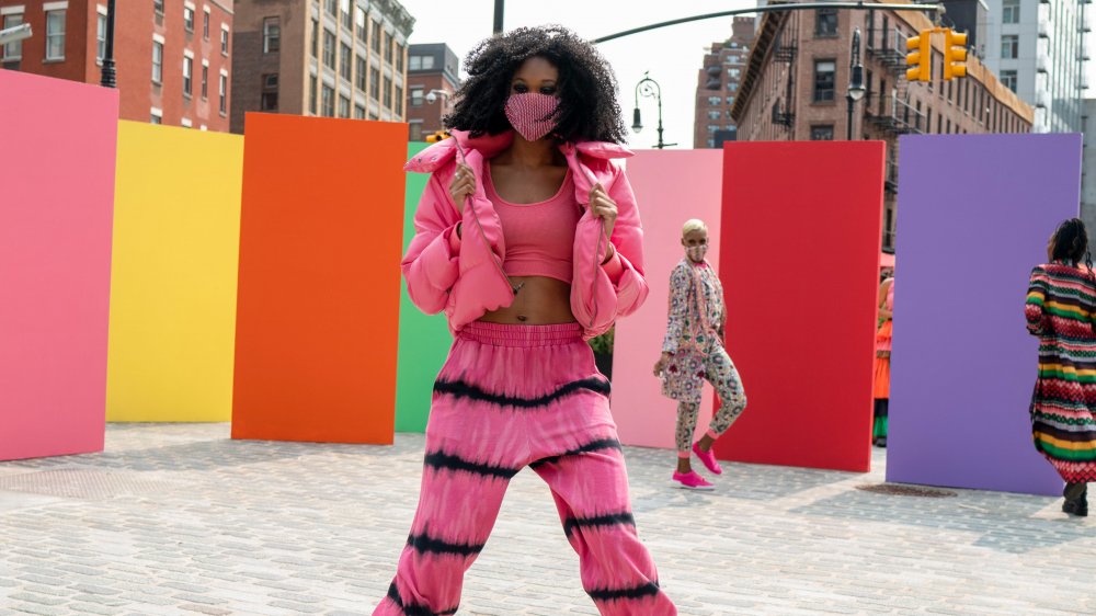 A woman wearing a pink sweatsuit at Fashion Week