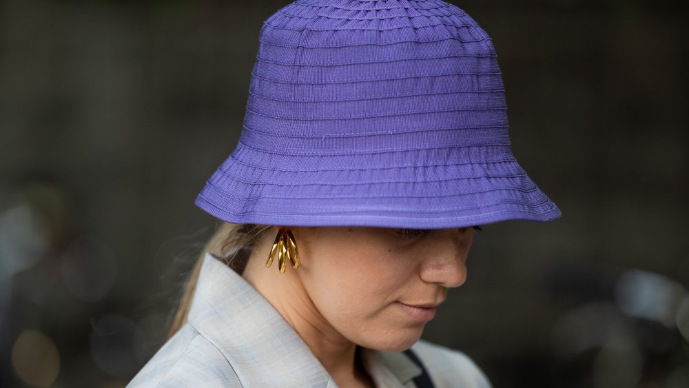 woman wearing purple bucket hat, a fashion trend that isn't worth the money