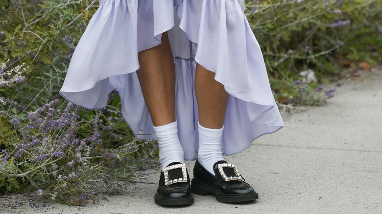 Woman in loafers and a purple dress