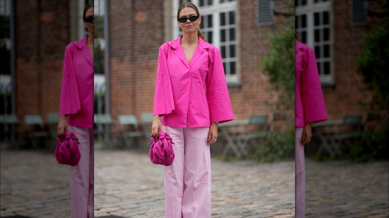 Woman wearing all pink outside a house