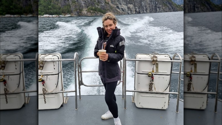 Faye Clarke holding cup at stern