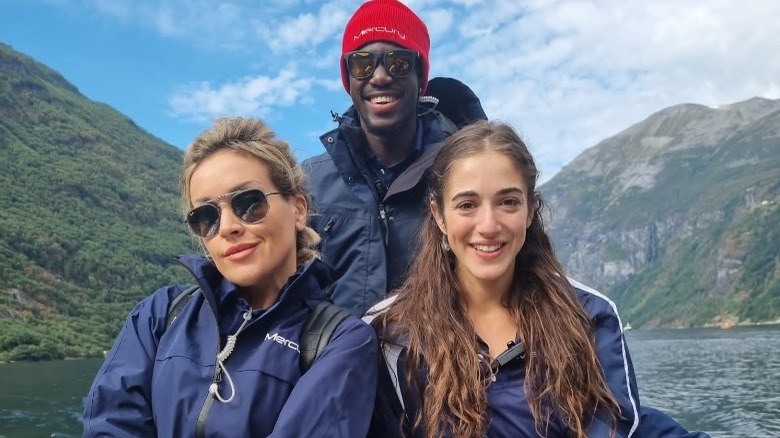 Faye Clarke with crew members in front of scenery