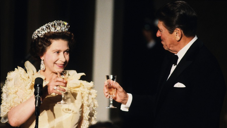 Queen Elizabeth and President Ronald Reagan toasting each other 