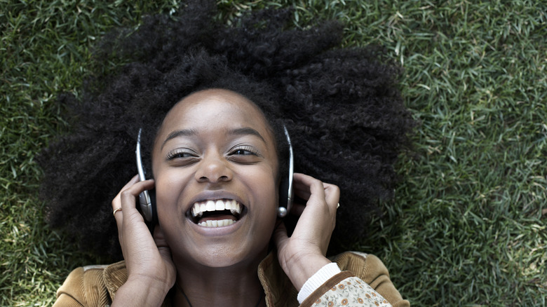 Woman happily listening to music