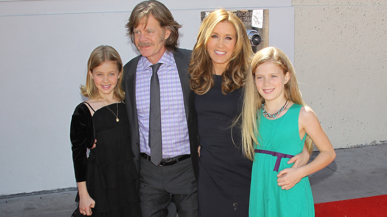 Felicity Huffman and William H. Macy posing with their children
