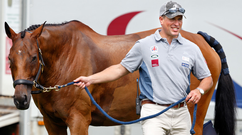 Peter Phillips leading a horse 