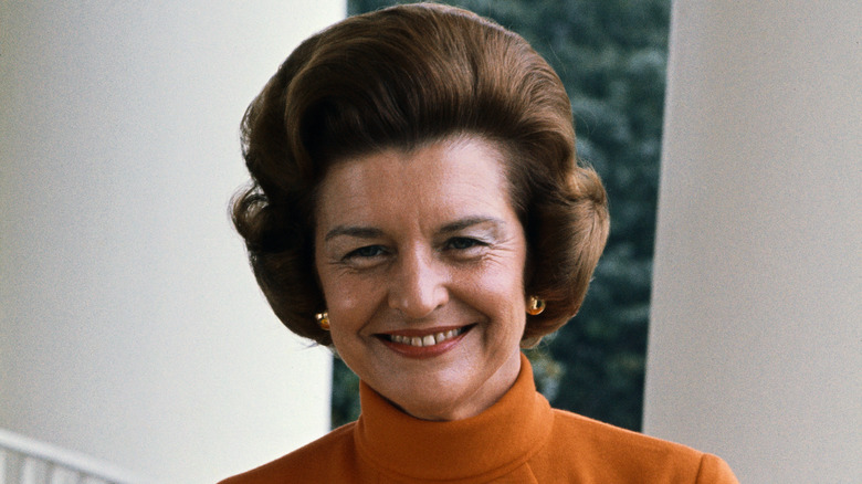 Betty Ford wearing orange, smiling