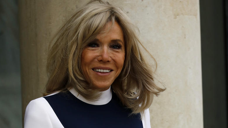 Brigitte Macron wearing a dress, smiling