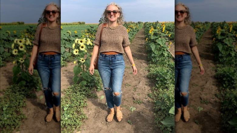 Woman walking sunflower patch