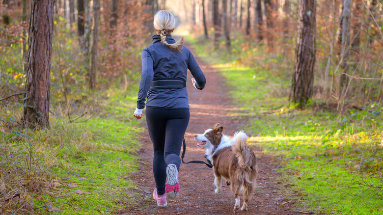 Woman walking outdoors with dog