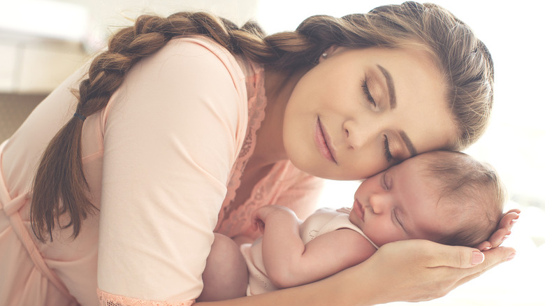 Woman holding baby close