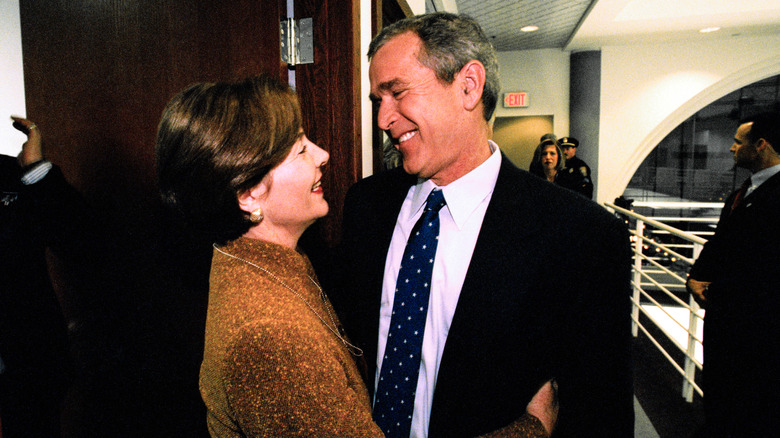 Laura and George W. Bush smiling at each other