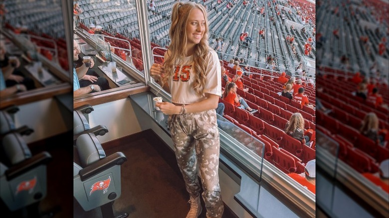 Brittany Mahomes poses in a crop jersey and camo sweat pants (2020)