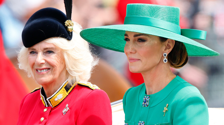 Queen Camilla smiling and Catherine, Princess of Wales, smiling very slightly