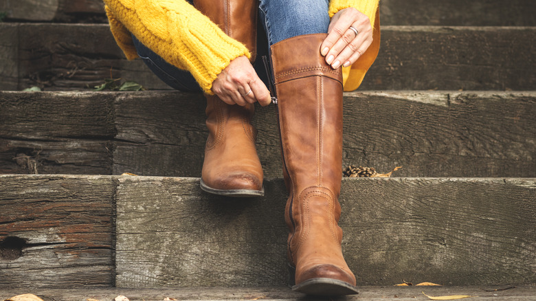 Women putting on leather boots