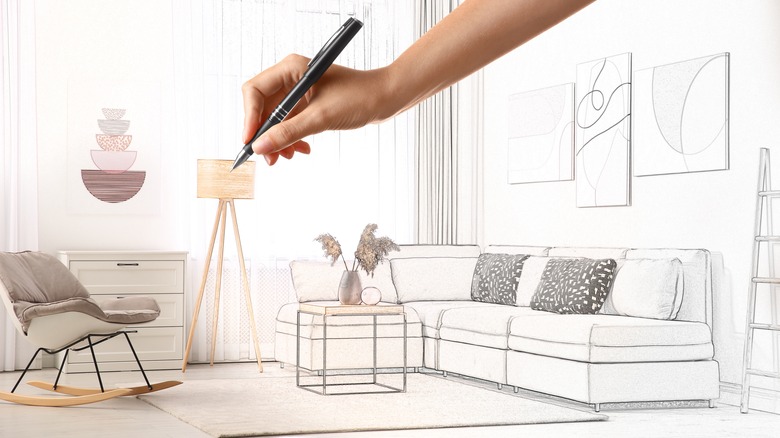 Woman's hand designing new living room