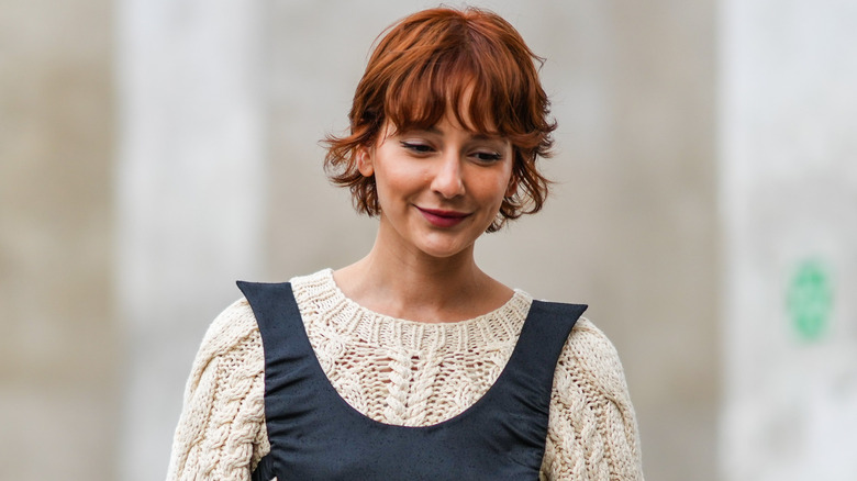 woman with short red hair smiling 