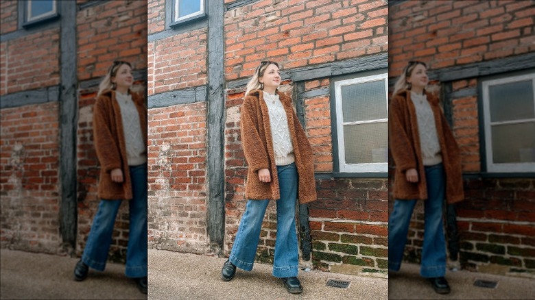 Woman in fur coat and flare jeans