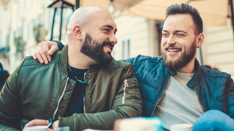 two men smiling and talking