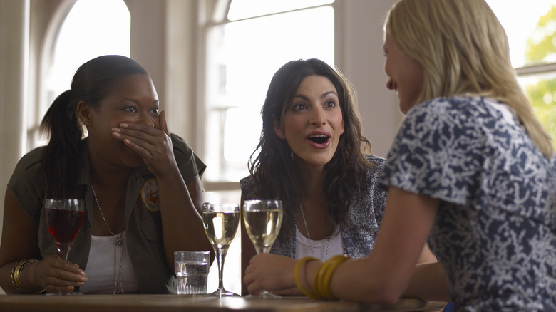 ladies gossiping over wine