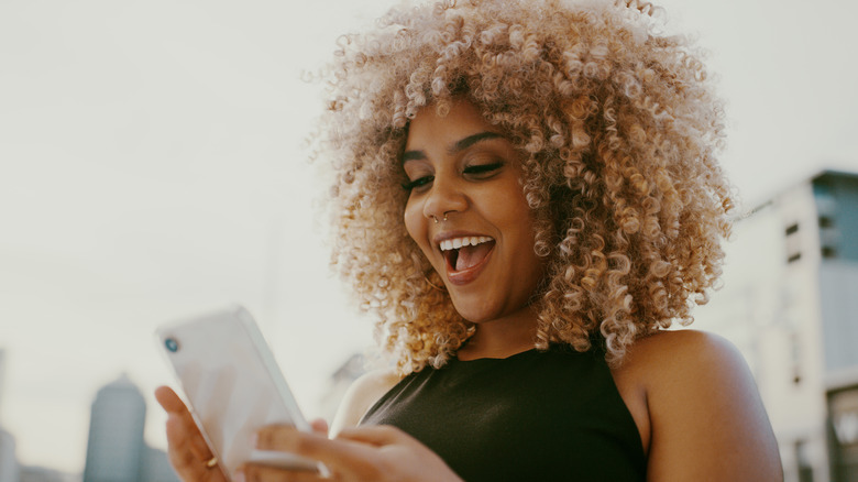 Woman looking nervously at her phone