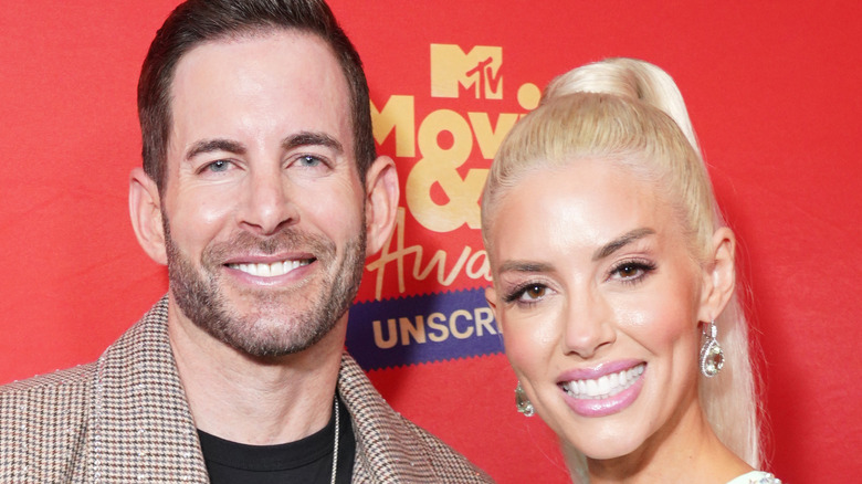 Tarek El Moussa and Heather Rae Young pose at the MTV Movie Awards together