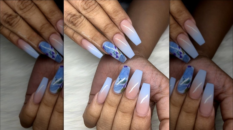 Hands showing milk bath nails with blue ombre design