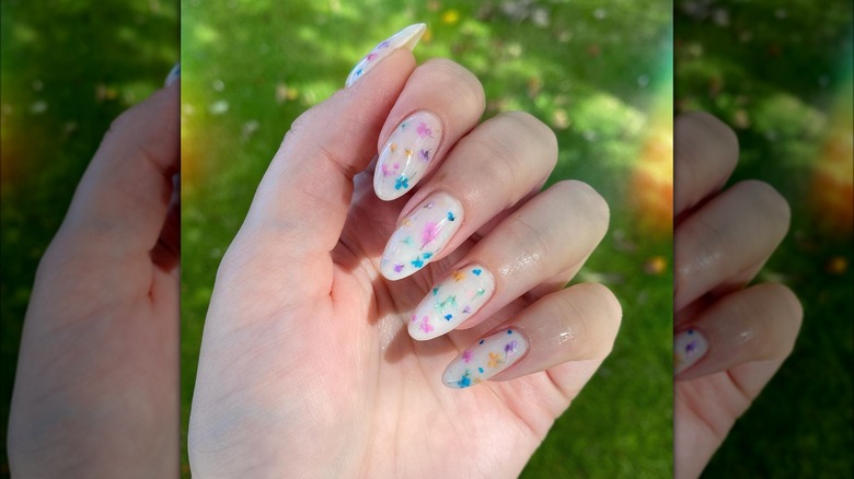 Hand showing nails with dainty flower design