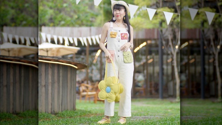 woman wearing flower bag and earrings