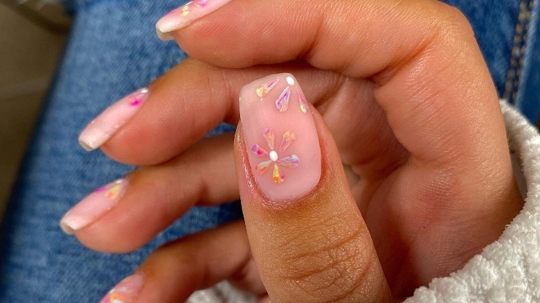 neutral color manicure with rainbow flowers