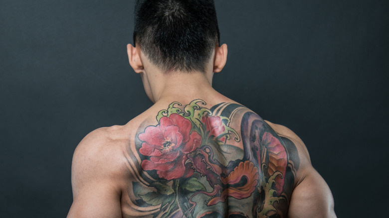 Man with flower tattoo on back