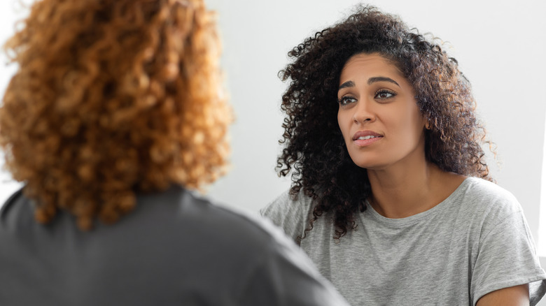 woman with curly hair listening to partner