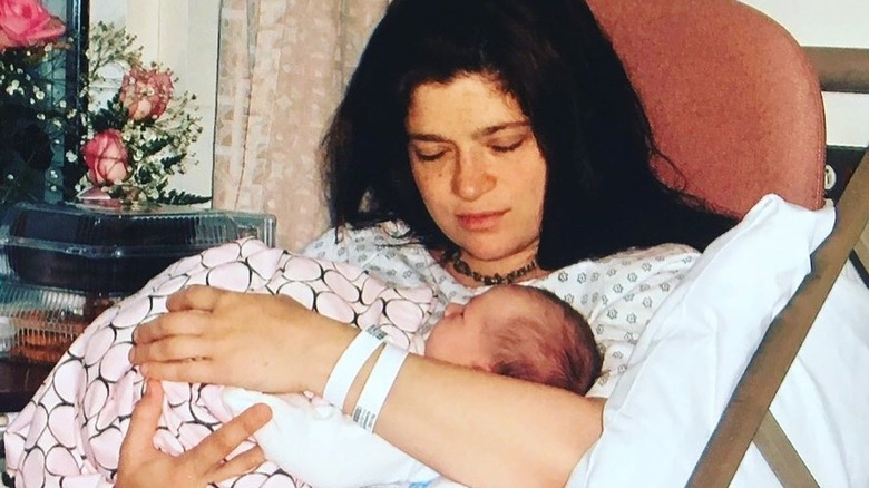 Alex Guarnaschelli holding her newborn daughter Ava in 2007