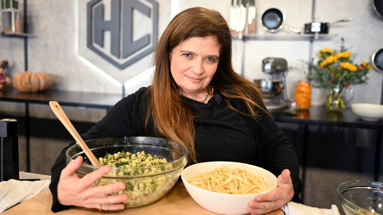 Alex Guarnaschelli posing with bowls of food