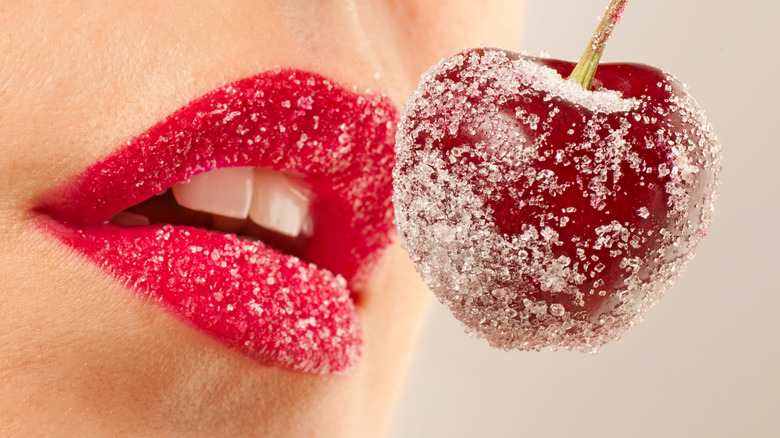 woman eating sugar covered cherry