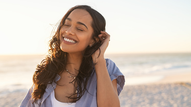 woman feeling happy on beach