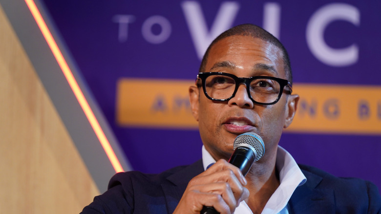 don lemon in glasses with microphone